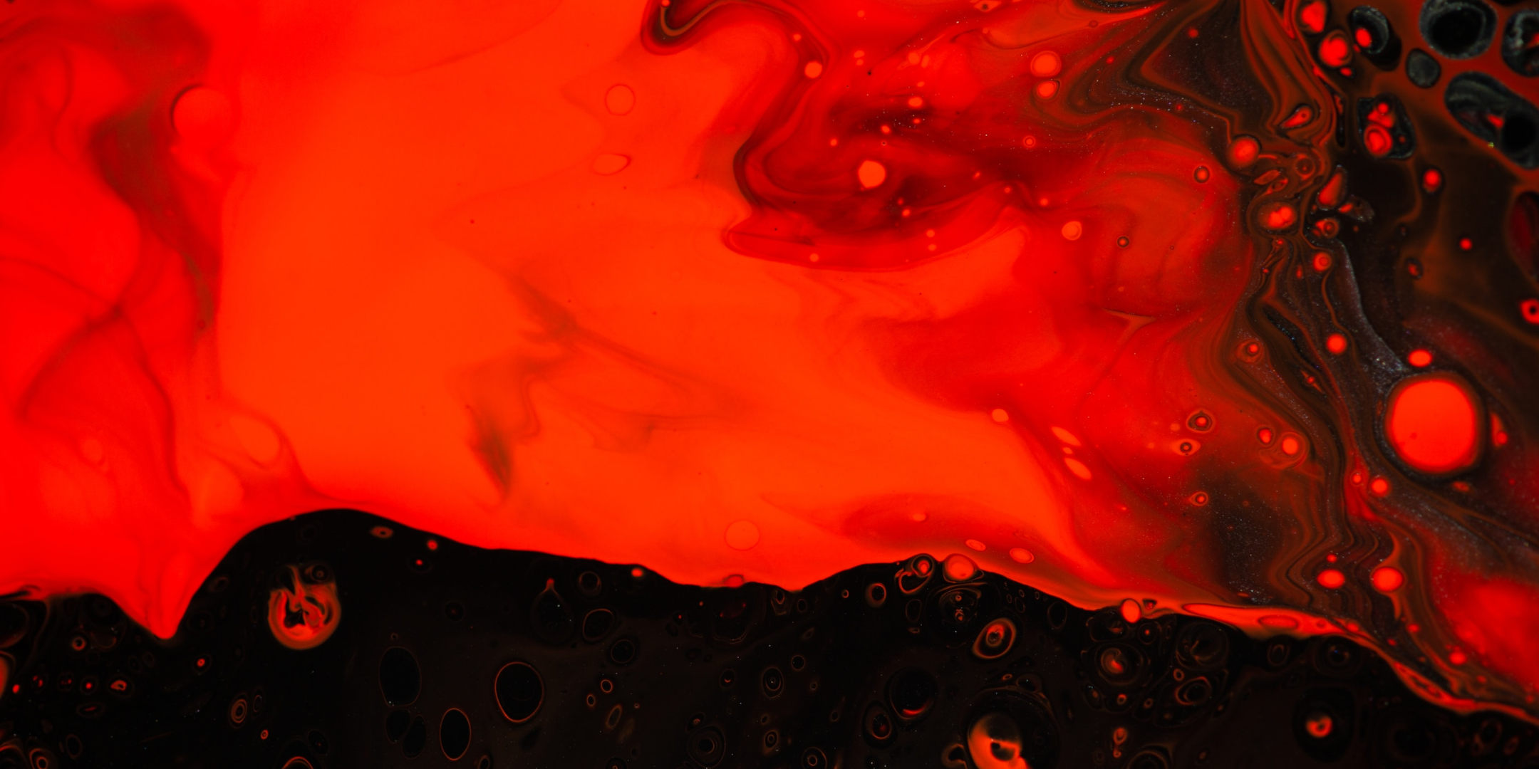 Uma imagem abstrata em preto e vermelho, com este último tendo um aspecto de fluído